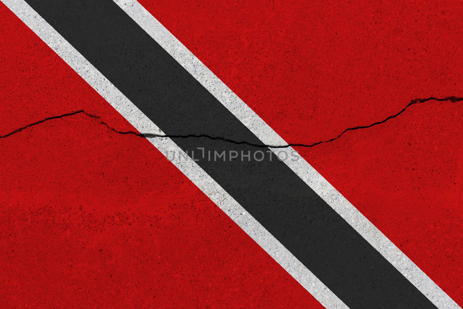 Trinidad and Tobago flag on concrete wall with crack. Patriotic grunge background. National flag of Trinidad and Tobago