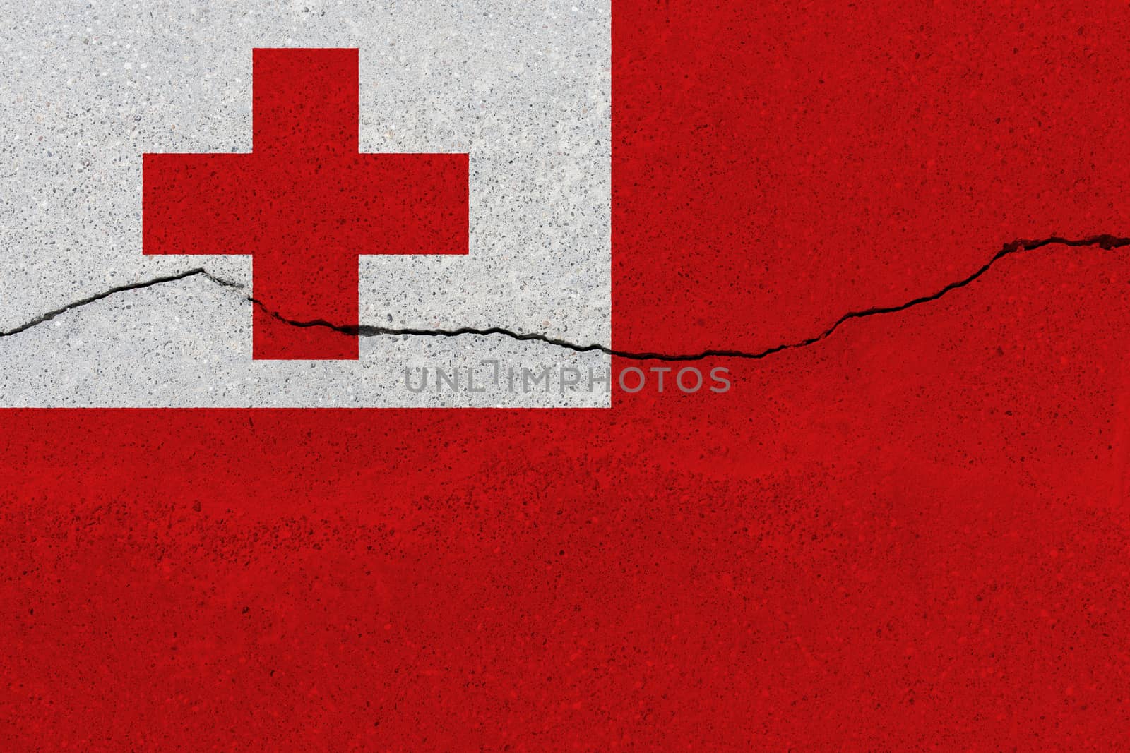 Tonga flag on concrete wall with crack. Patriotic grunge background. National flag of Tonga