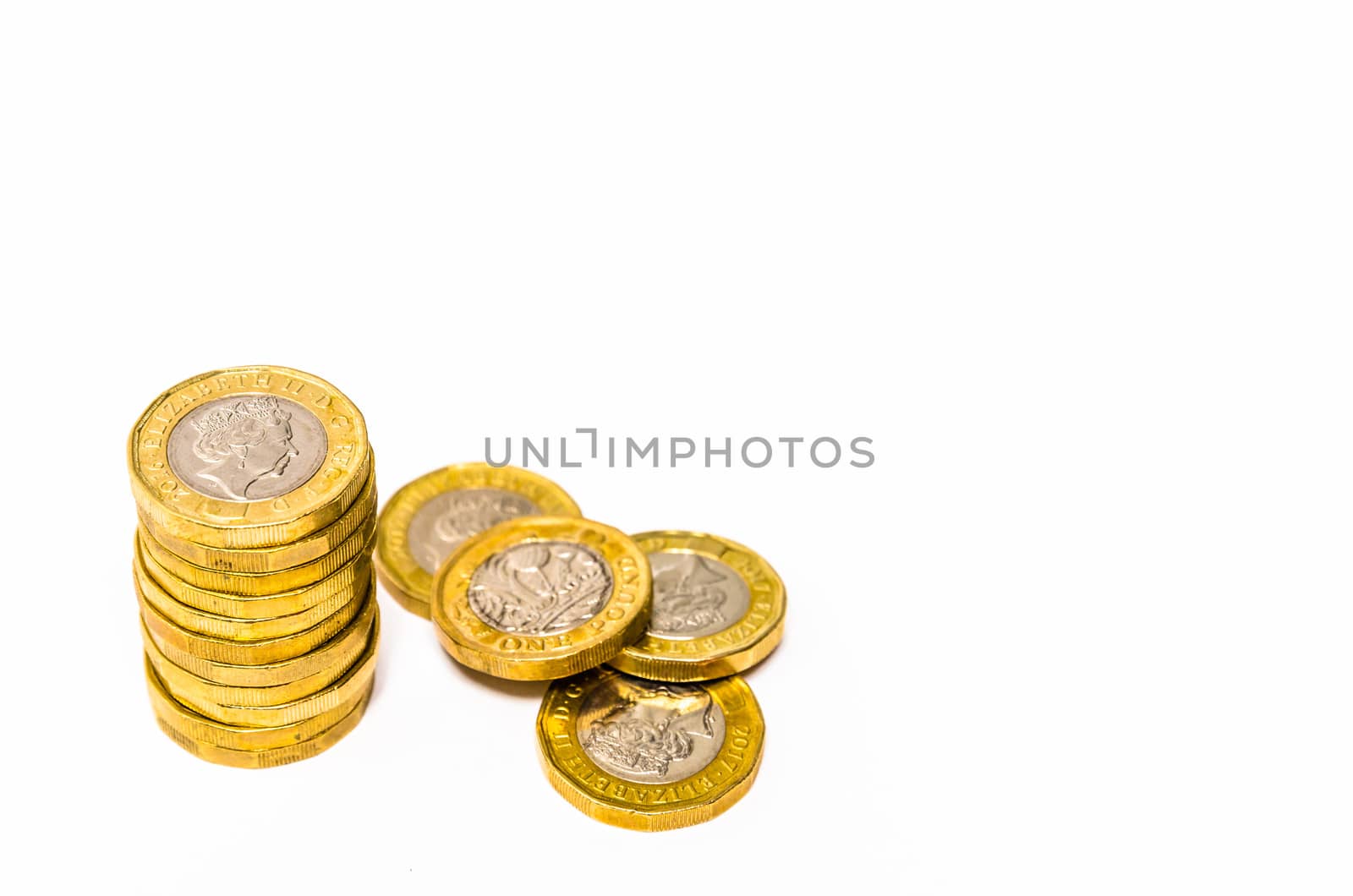 Shiny new one pound coins distributed on a white background