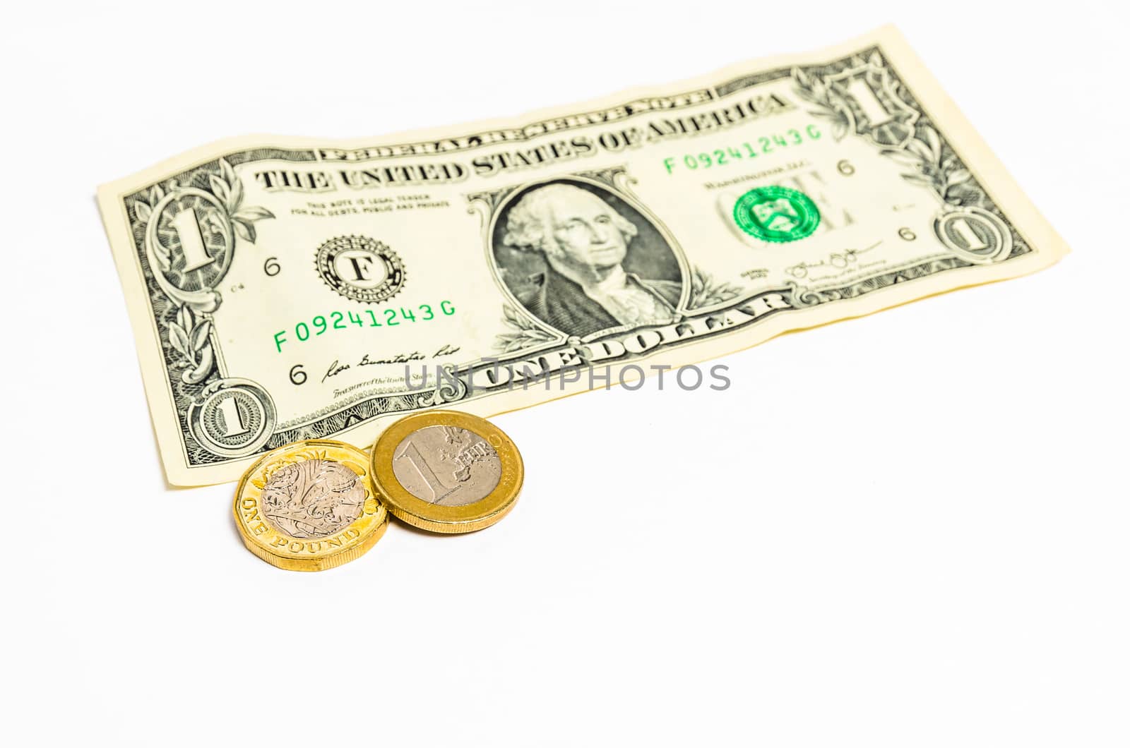 Shiny one Pound and one Euro coins and a one Dollar note lying on a white background
