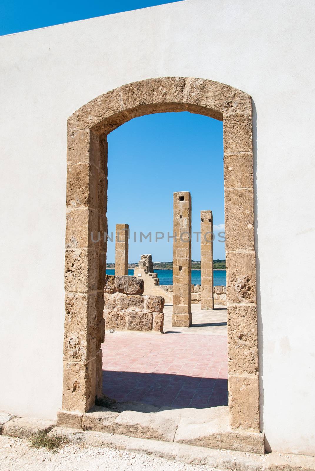 Through a door of an old tuna-fishery building in Vendicari nature reserve, Sicily, Italy