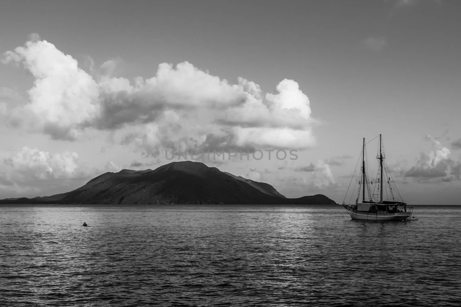 Black and white of a boat off the coast of Fitzroy Island in the morning light