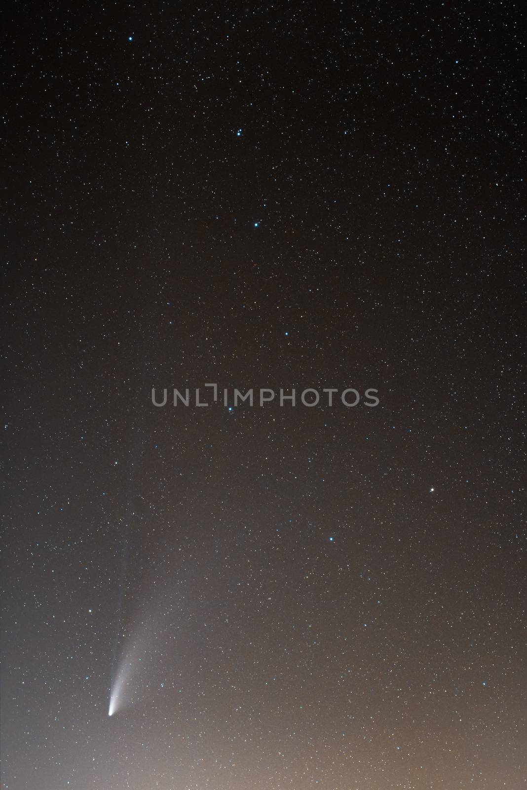 Neowise Comet and its two long tails below Ursa Major constellation. 35mm lens and photo stacking. Sicily, Italy