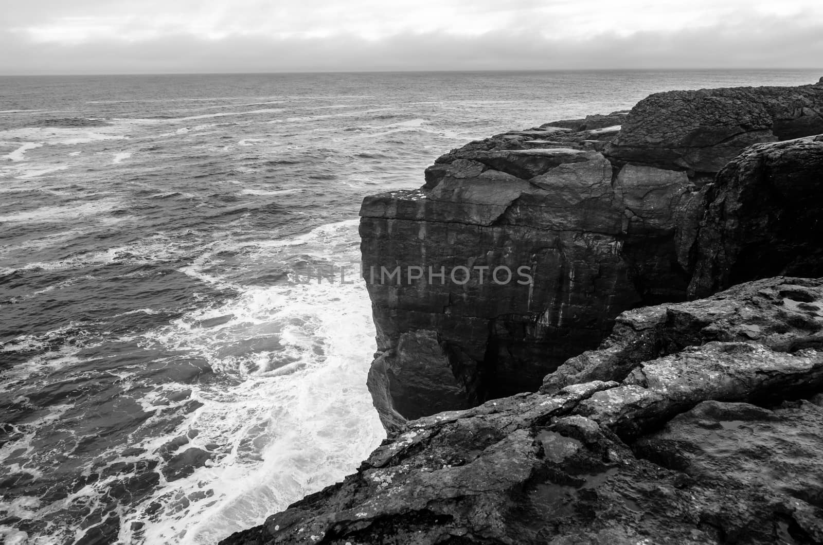 Black and white seascape of Irish cliffs in stormy weather, Ireland
