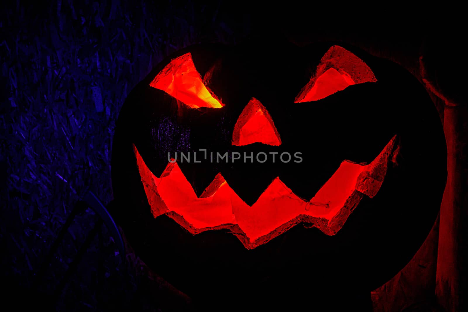 Smiling pumpkin on Halloween. The red glow from the inside