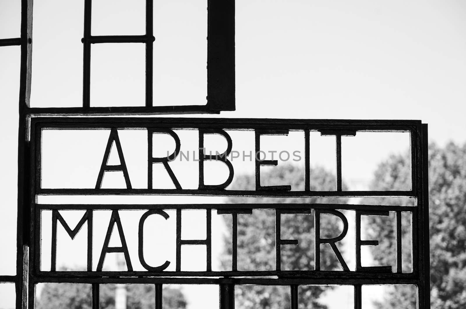 Black and white close up of the famous sign Arbeit macht frei on the gate of Sachsenhausen concentration camp in Berlin