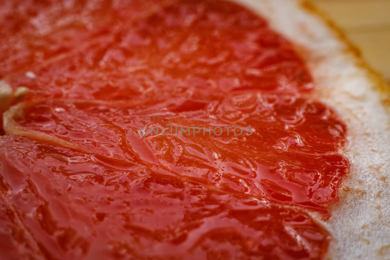 Slice of grapefruit close up by 9parusnikov