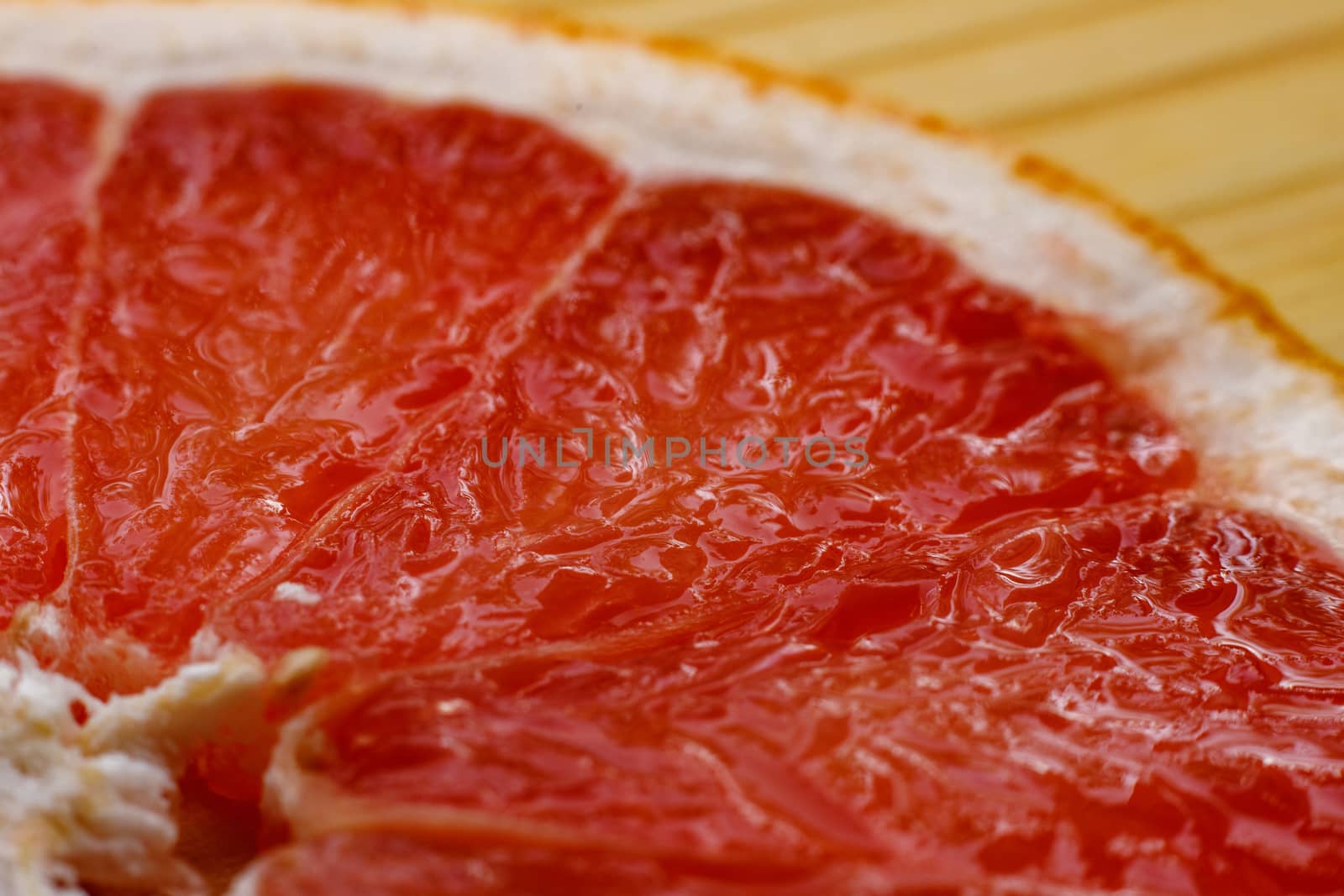 Slice of grapefruit close up by 9parusnikov