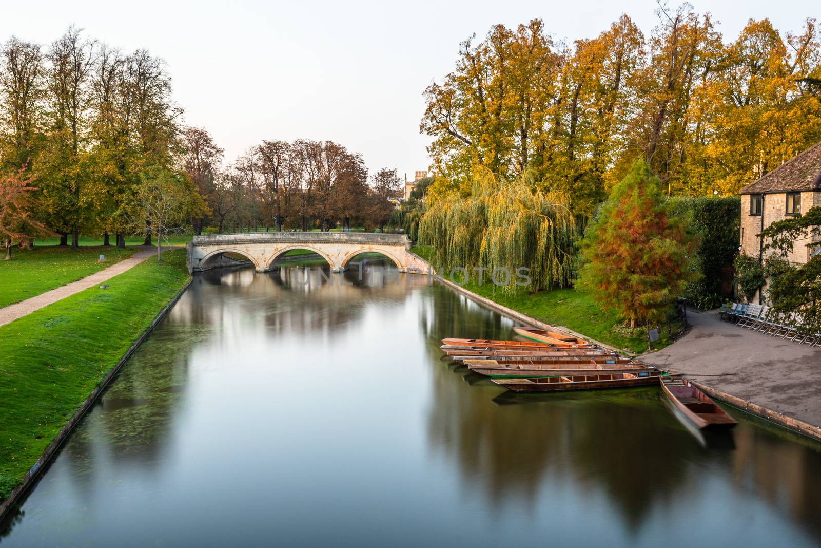 Long exposure shot of river Cam and punts near the historical Colleges Kings, Trinity and St john, Cambridge, UK