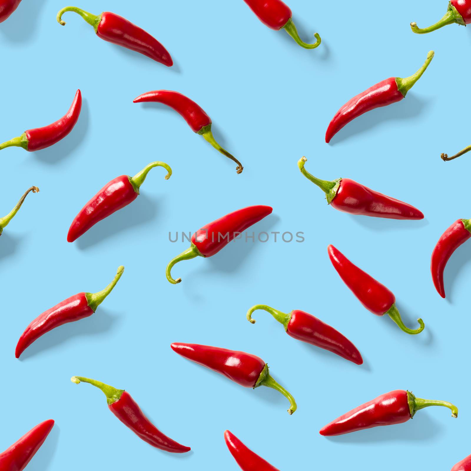 Seamless pattern made of red chili or chilli on blue background. Minimal food pattern. Red hot chilli seamless peppers pattern. Food background. by PhotoTime