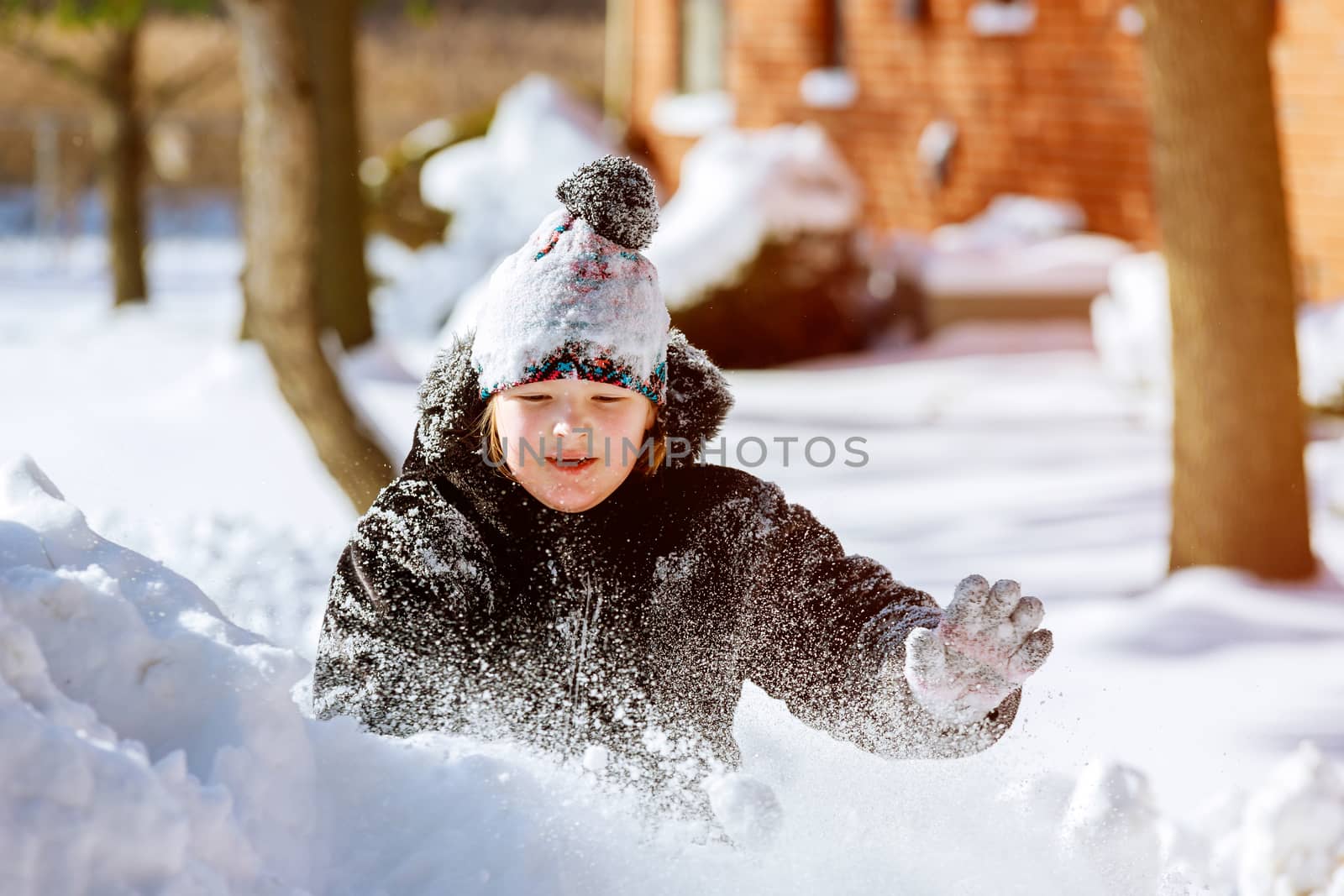 Snow on home drive way little child play outdoors on snowy by ungvar