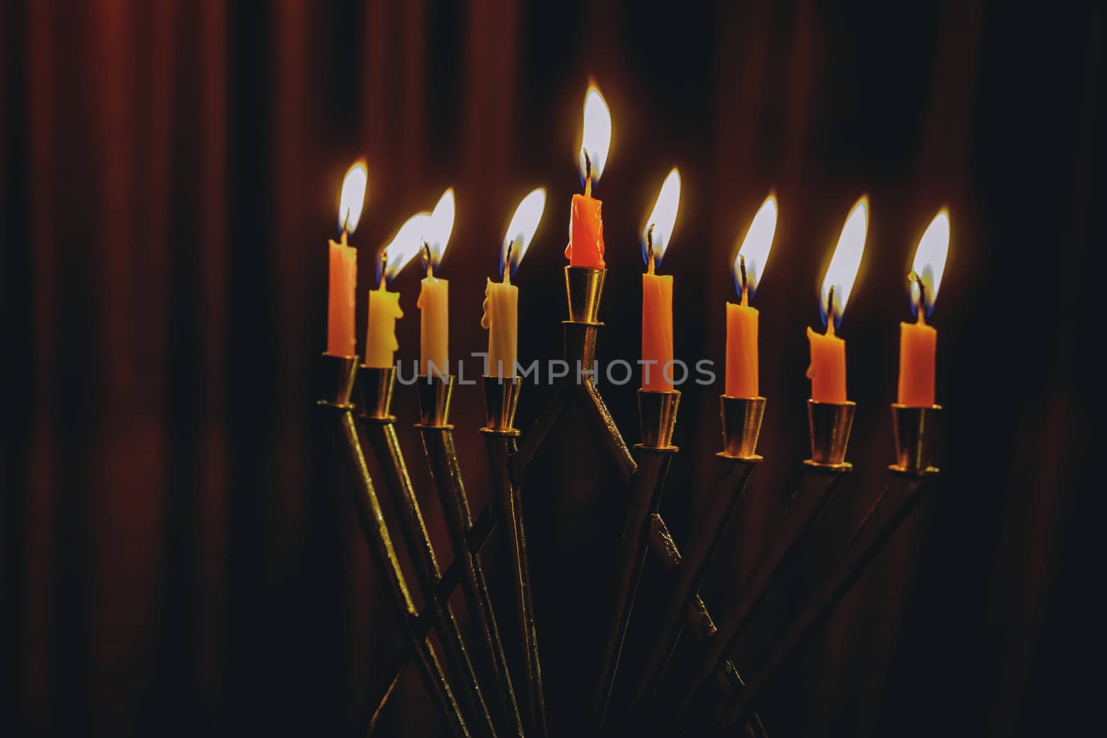 Hanukkah menorah with burning candles by ungvar