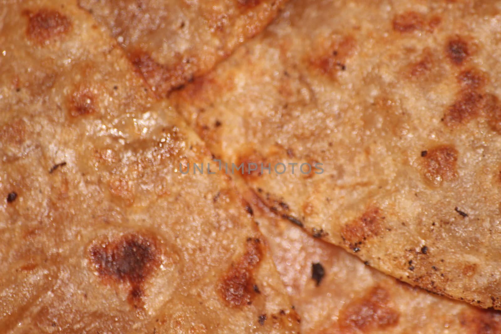 Traditional paratha - Macro closeup with selective focus of homemade oily bread or parotta. Chapati is traditional food of southeast Asia.