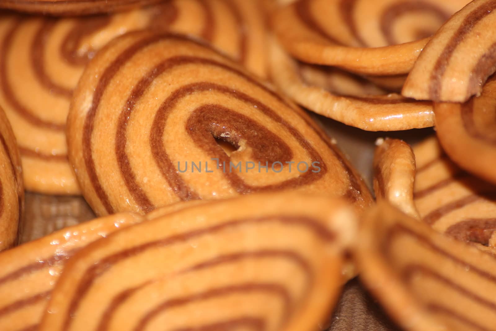 Closeup view with selective focus of a large number of round cookies by Photochowk