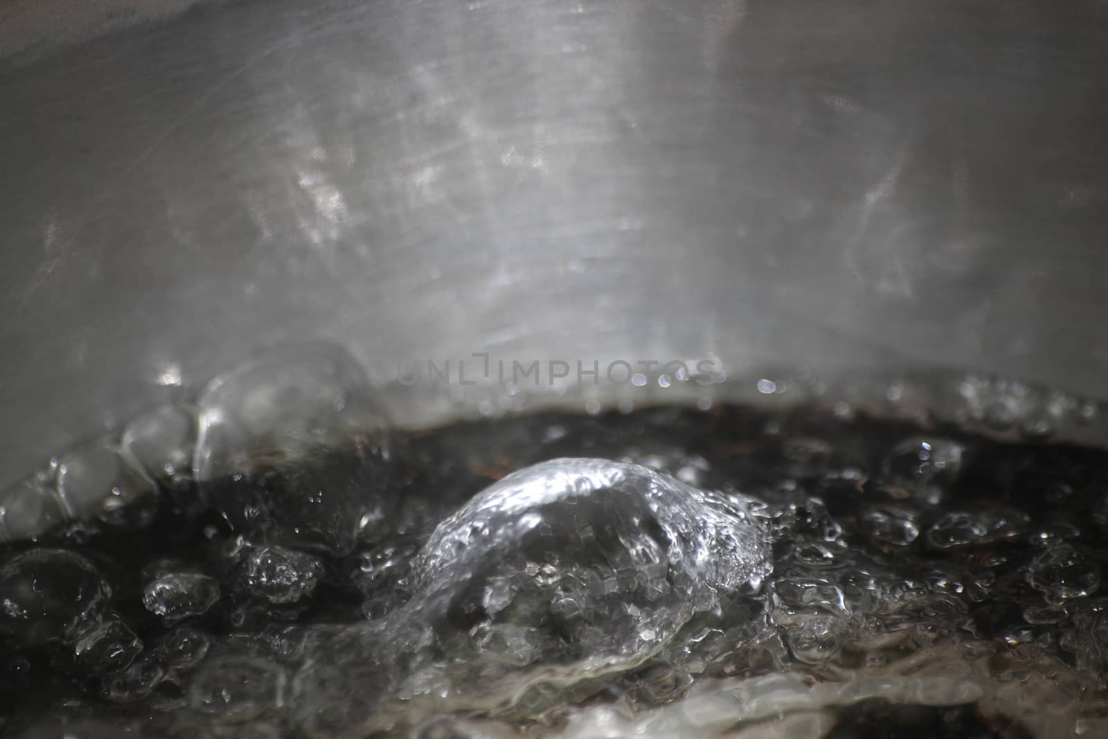 Closeup macro photograph with selective focus of boiling water by Photochowk