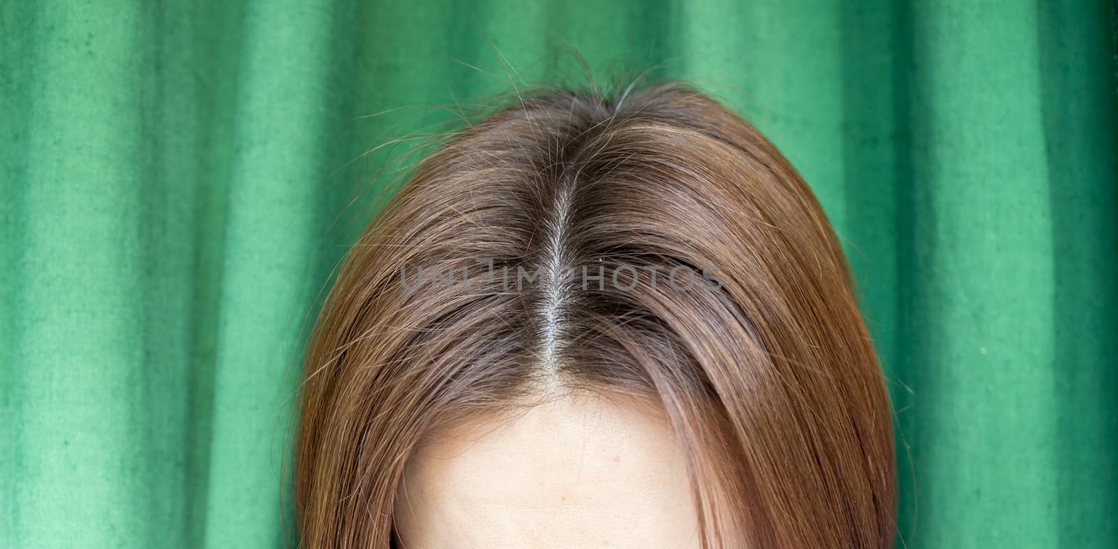Women's hair after washing on a green background. the view from the top. 