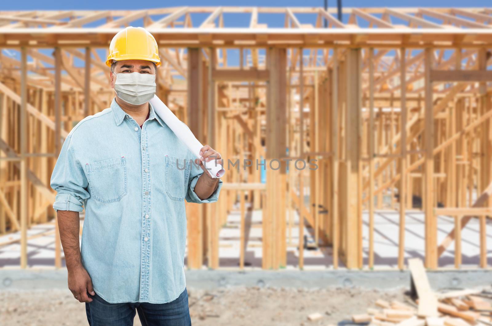 Male Contractor In Hard Hat Wearing Medical Face Mask During Coronavirus Pandemic At Construction Site.