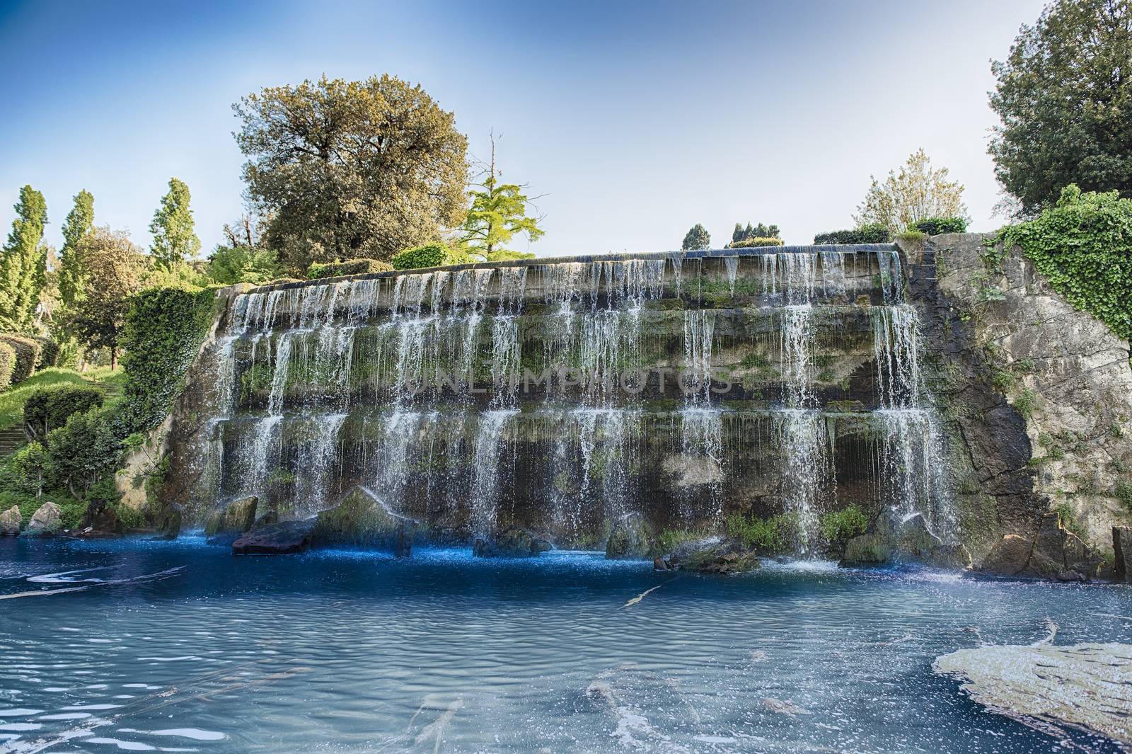 Scenic waterfall in the big fountain of EUR artificial lake, modern district in the south of Rome, Italy