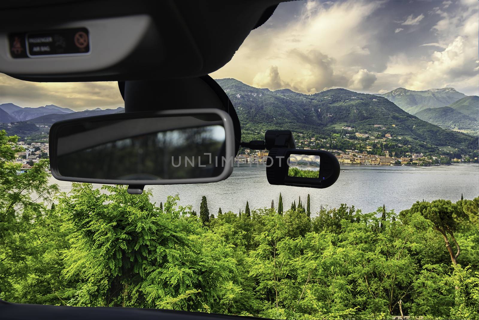 Looking through a dashcam car camera installed on a windshield with view of the town of Salo, on the Lake Garda, Italy