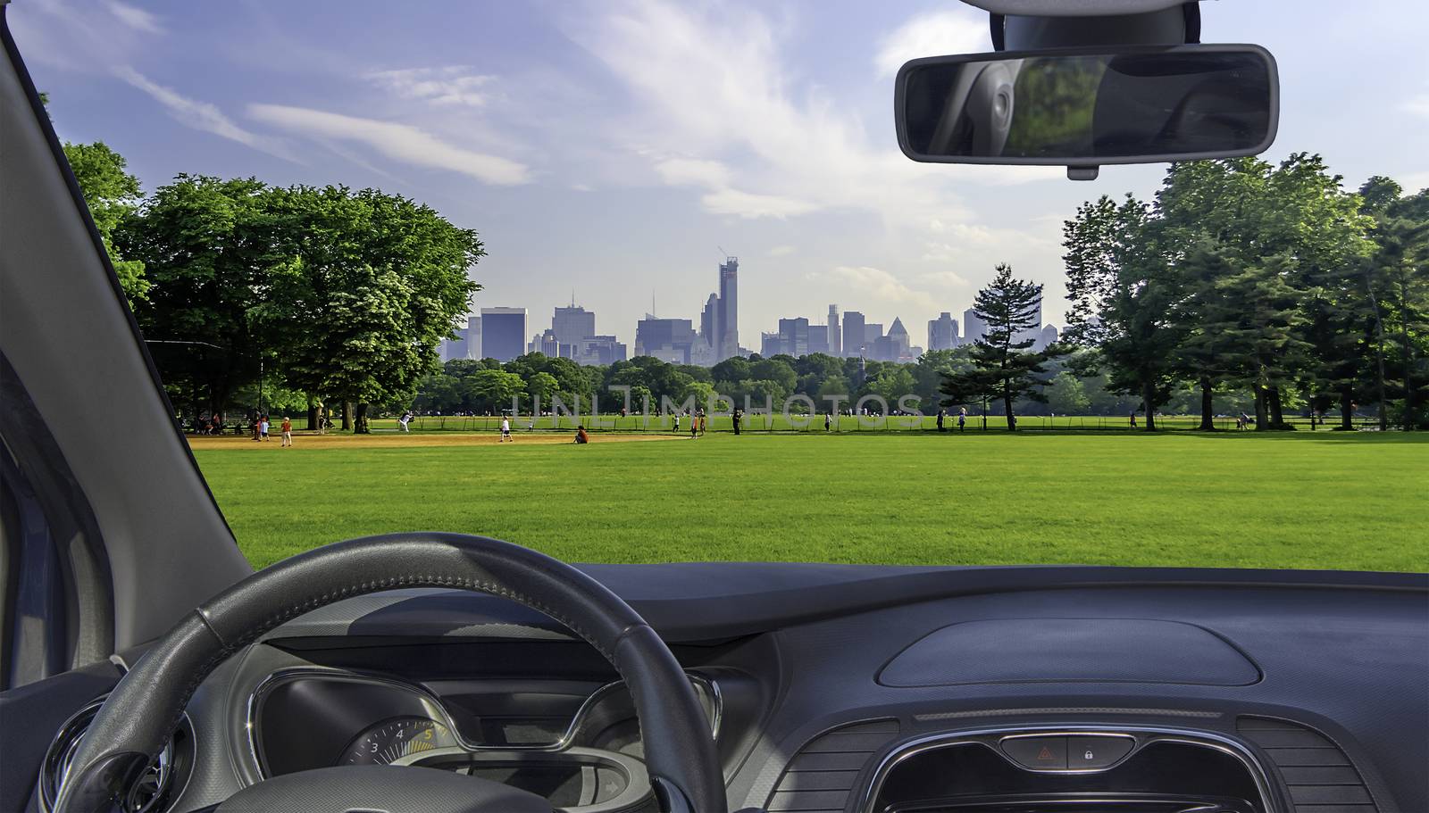 Looking through a car windshield with view of Central Park and a beautiful contrast between skyscrapers and buildings, Manhattan, New York City, USA