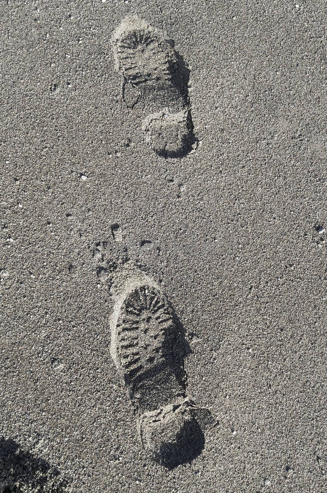 Shoe footprint imprints on a sandy beach