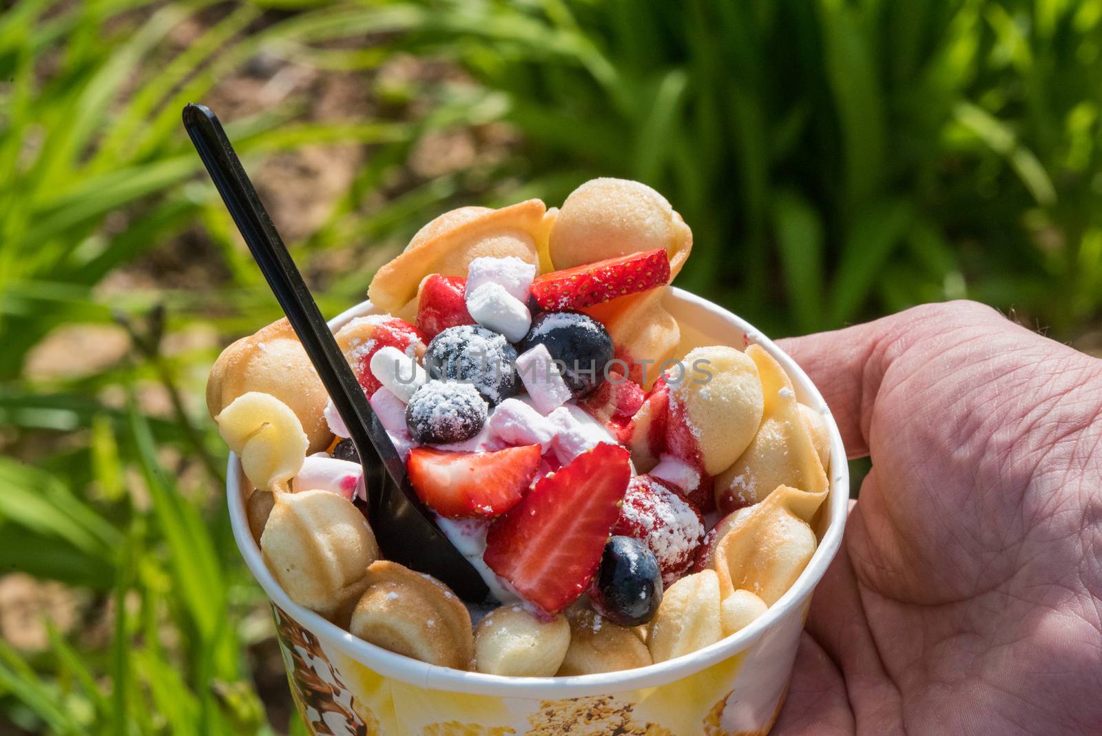 ice cream in waffle with blueberries and strawberries