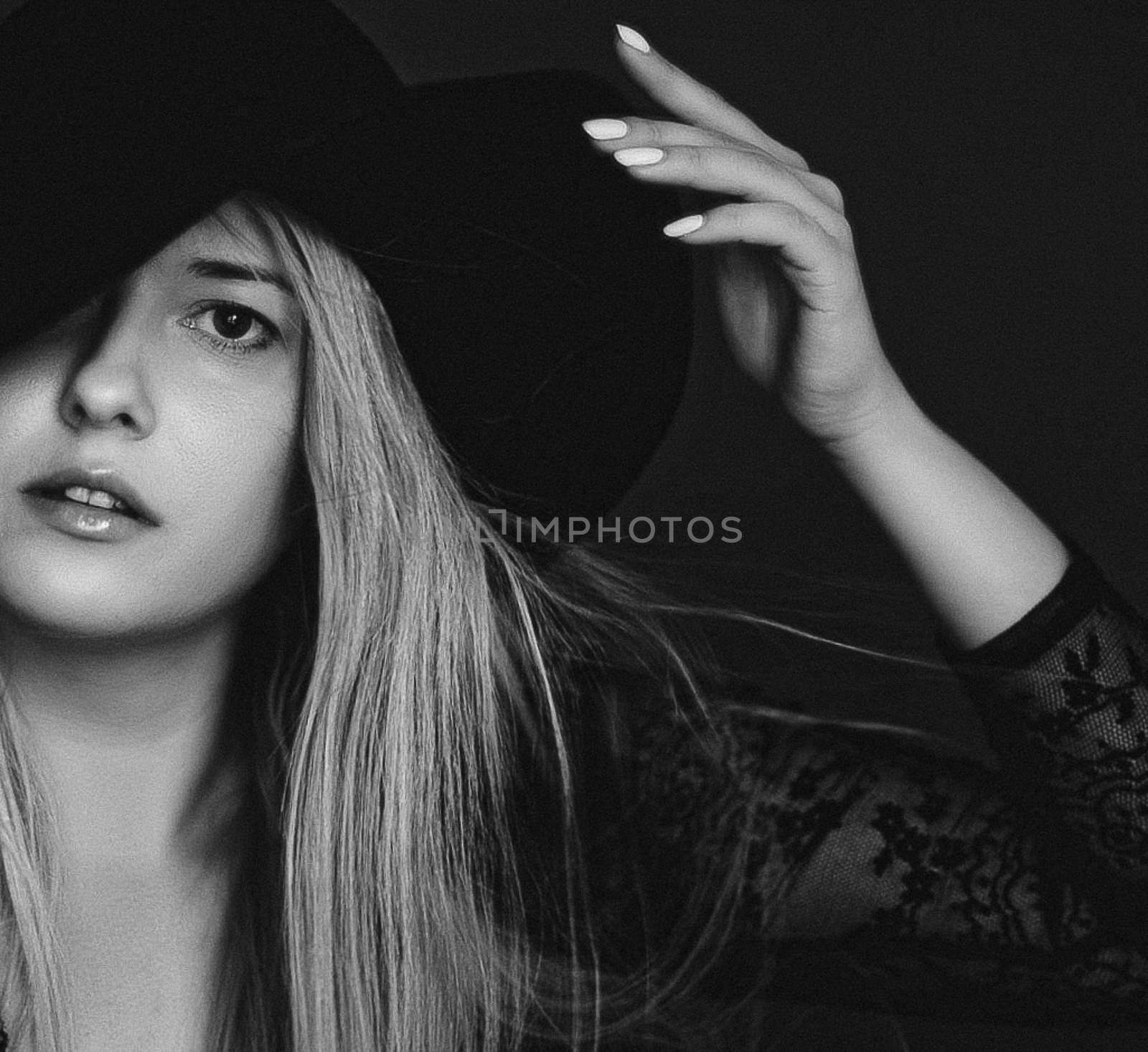 Beautiful blonde woman wearing a hat, artistic film portrait in black and white for fashion campaign and beauty brand by Anneleven