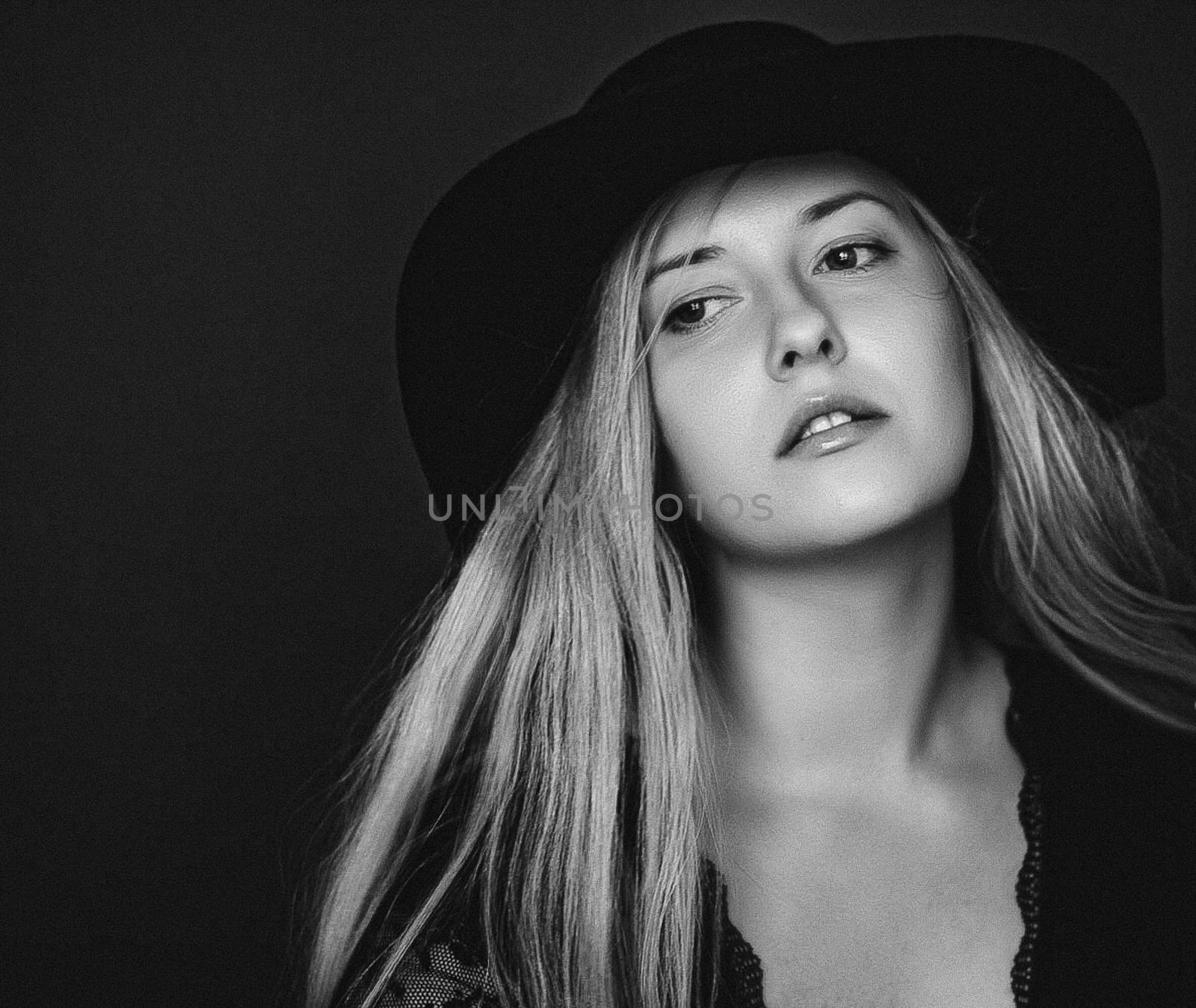 Beautiful blonde woman wearing a hat, artistic film portrait in black and white for fashion campaign and beauty brand by Anneleven