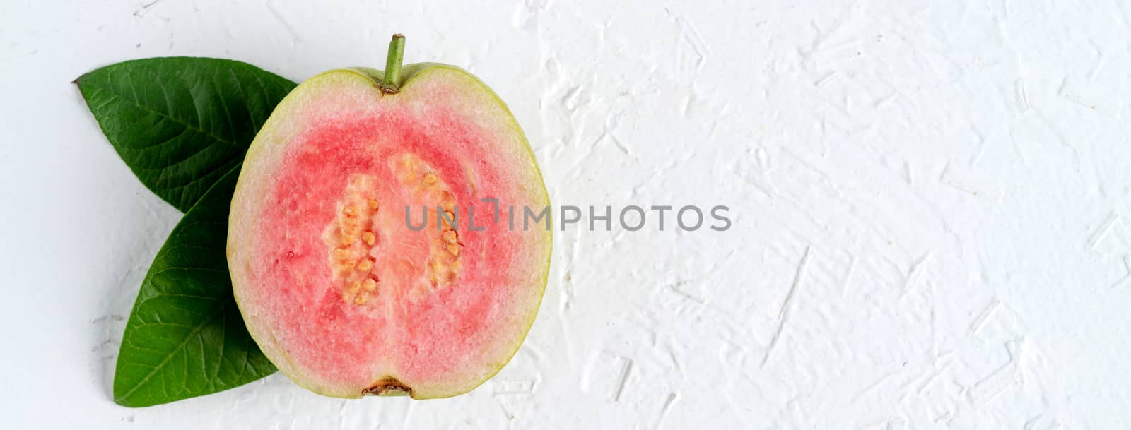 Top view, flat lay of delicious beautiful Red guava with fresh green leaves isolated on white table background, studio overhead table shot with copy space.