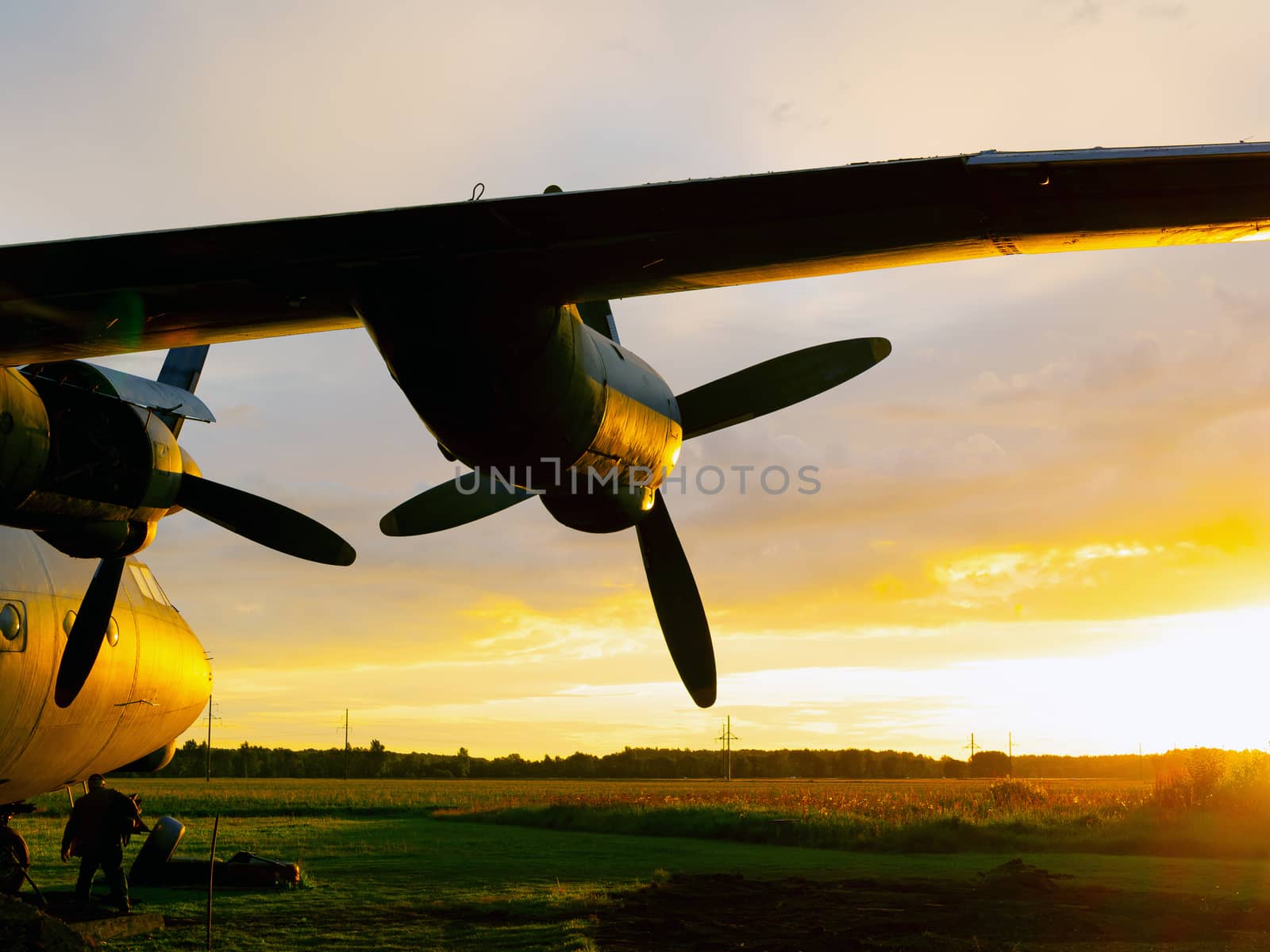 old Soviet military airplane, sunset time. Abandoned Historic Aircraft in Estonia AN-12. Close up of propeller engine. Copy space