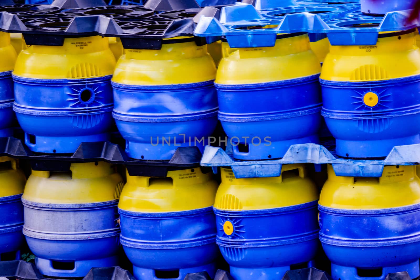 Image of a stack of blue and yellow beer barrels. by paddythegolfer