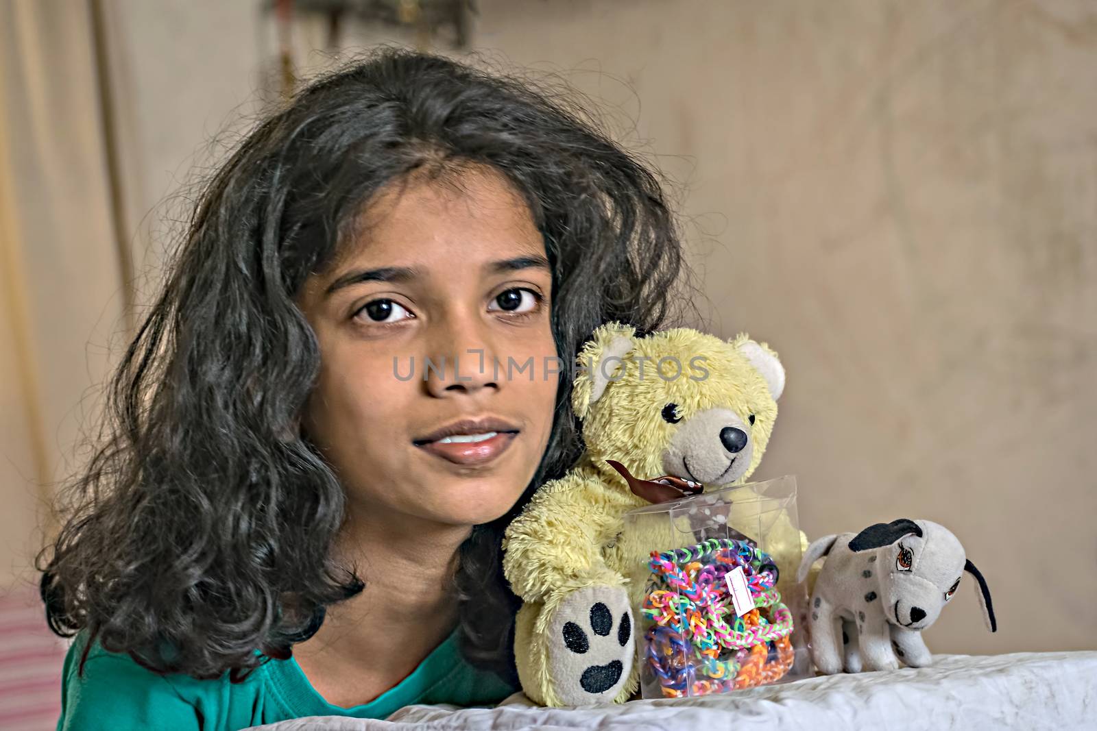 Young girl with her favorite soft toys - teddy bear and puppy.