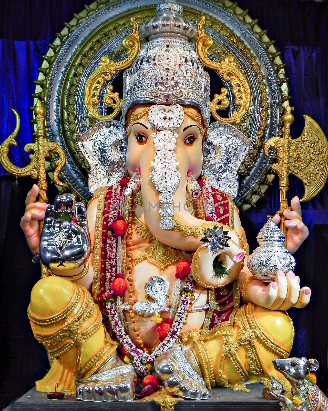 Portrait , closeup view of decorated and garlanded idol of Hindu God Ganesha in Pune, India.