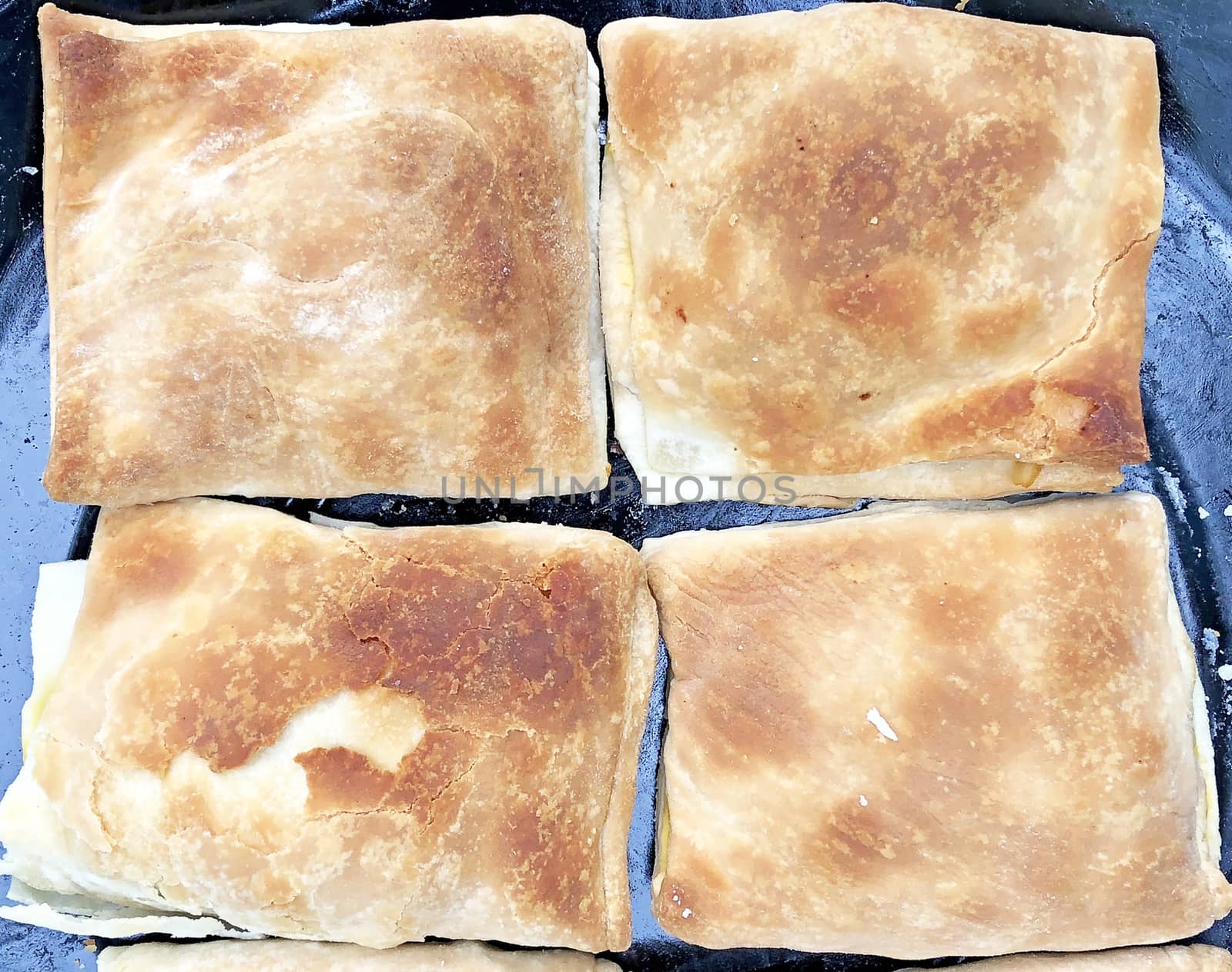 Full frame view of vegetable puffs kept in a plate for sale in the bakery after cooking in a microwave oven