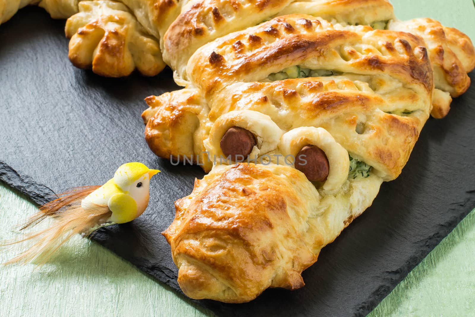 Original cake in form of crocodile with potatoes, cheese and herbs. Cake is served to Halloween party as fun and spooky monster