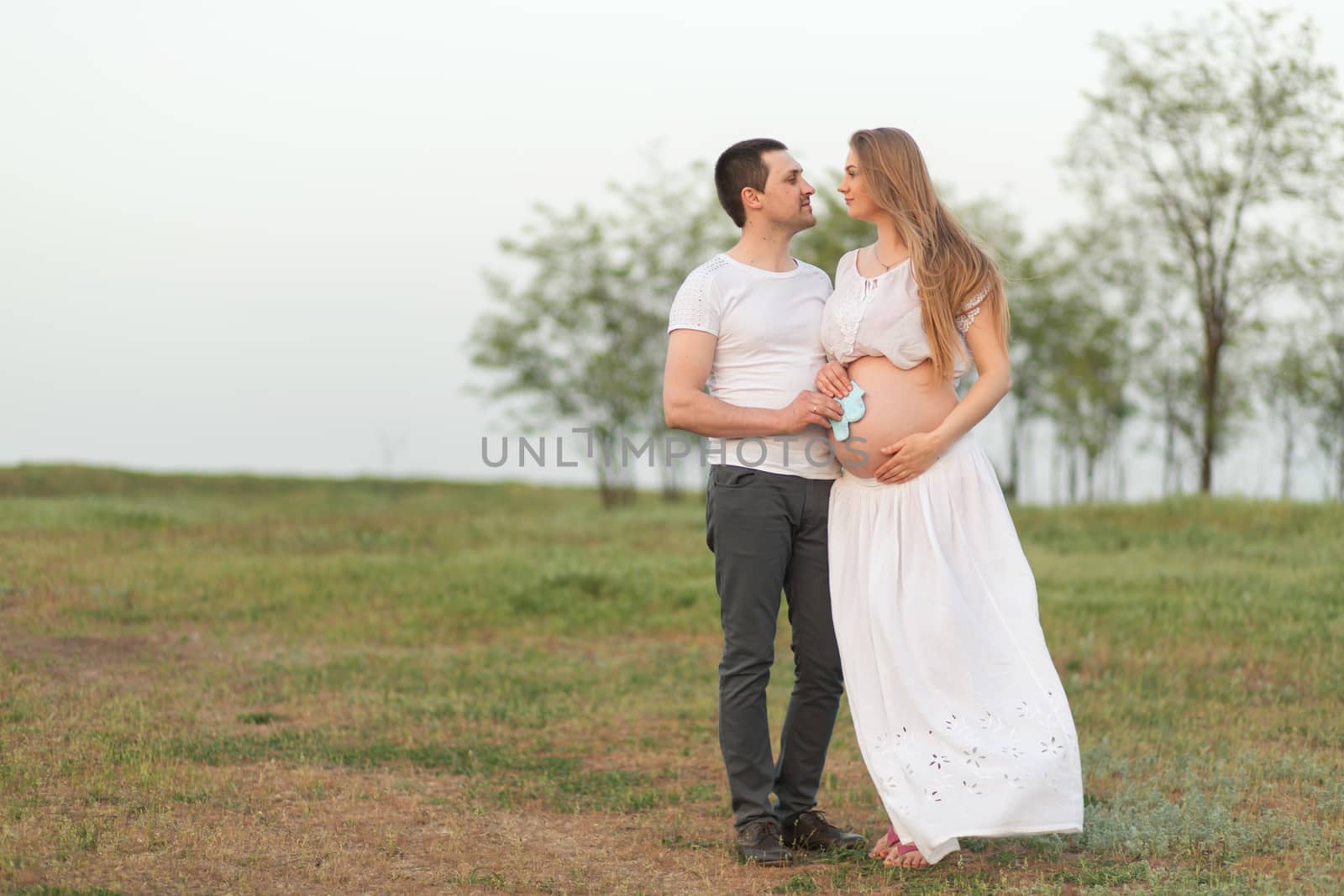 Happy moments of pregnancy. A loving husband with his pregnant w by Try_my_best