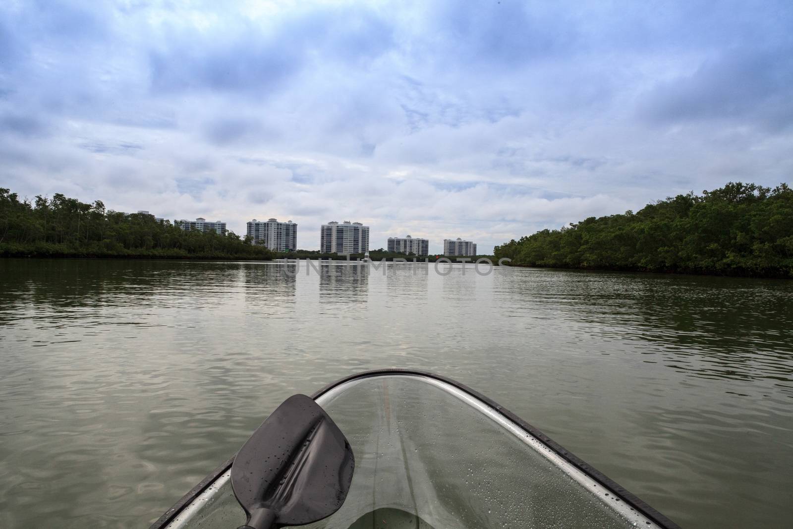 Clear see-through kayak forges its way through the waters of Delnor-Wiggins pass in Bonita Springs, Florida.