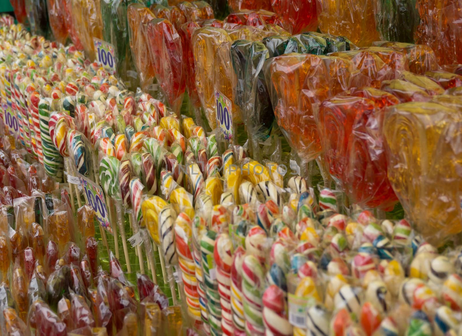 Counter with multicolored sweet lollipops of different shapes