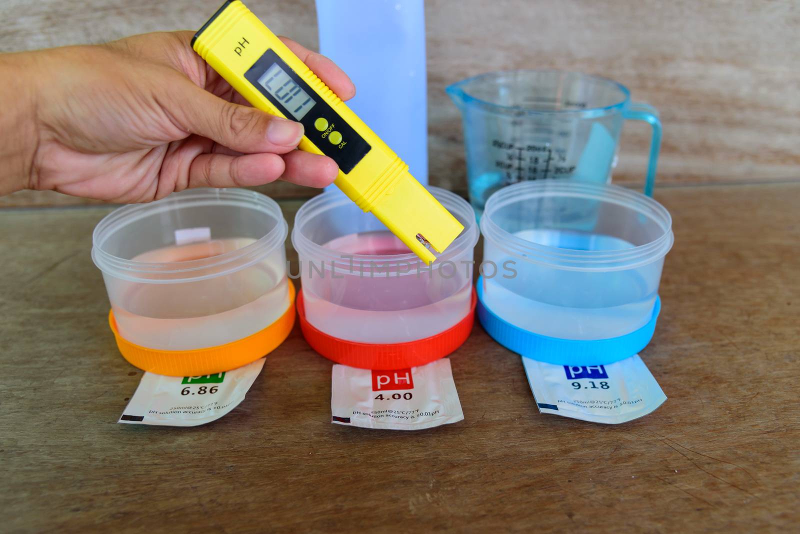 The man calibrate Ph meter before use it for tester