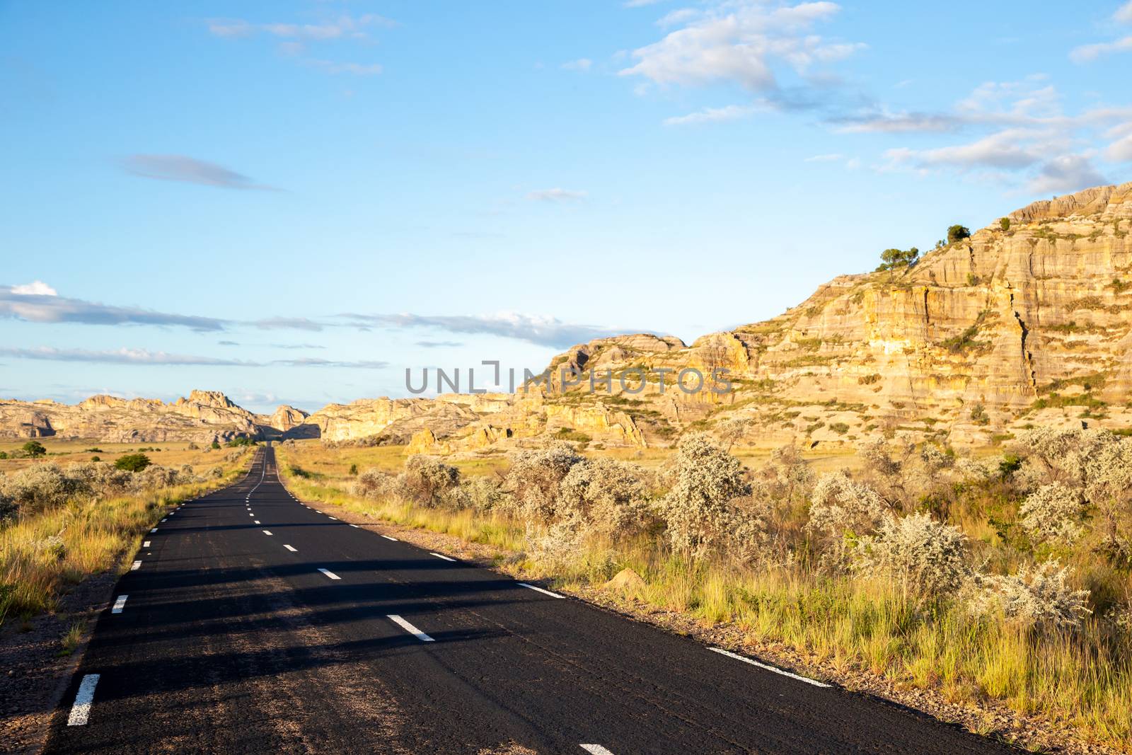 The asphalt road through the landscape of the island of Madagascar
