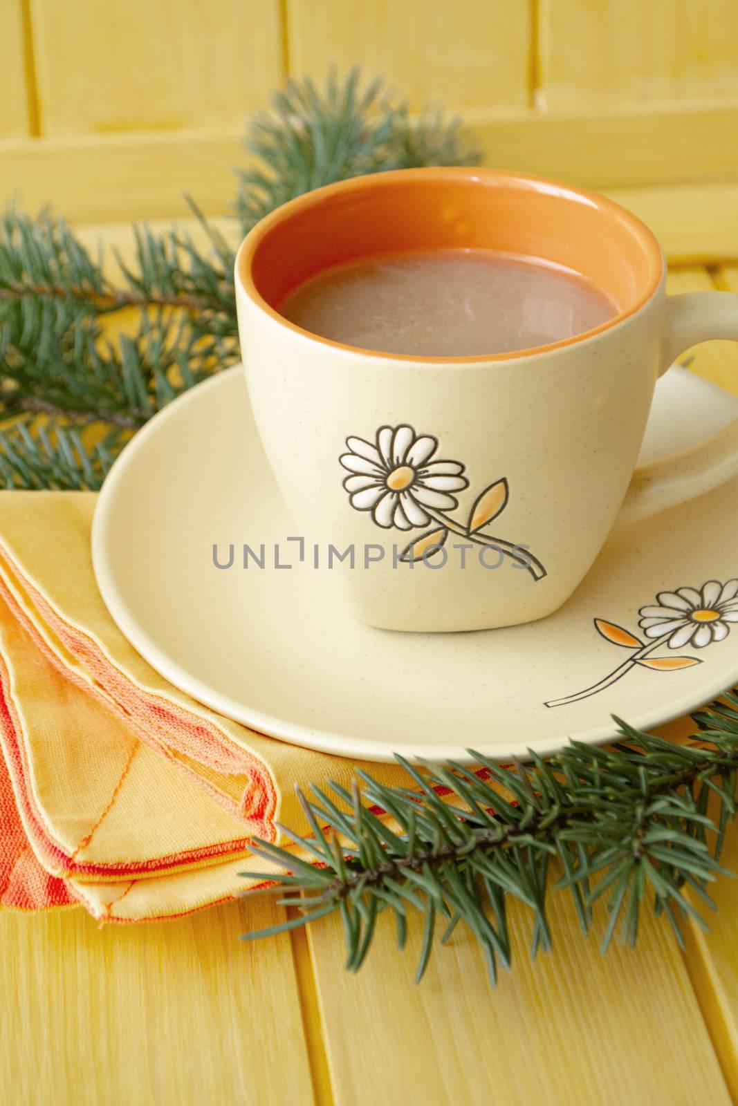 cup of hot cocoa or hot coffee latte, traditional beverage for winter time. Christmas concept, orange colors