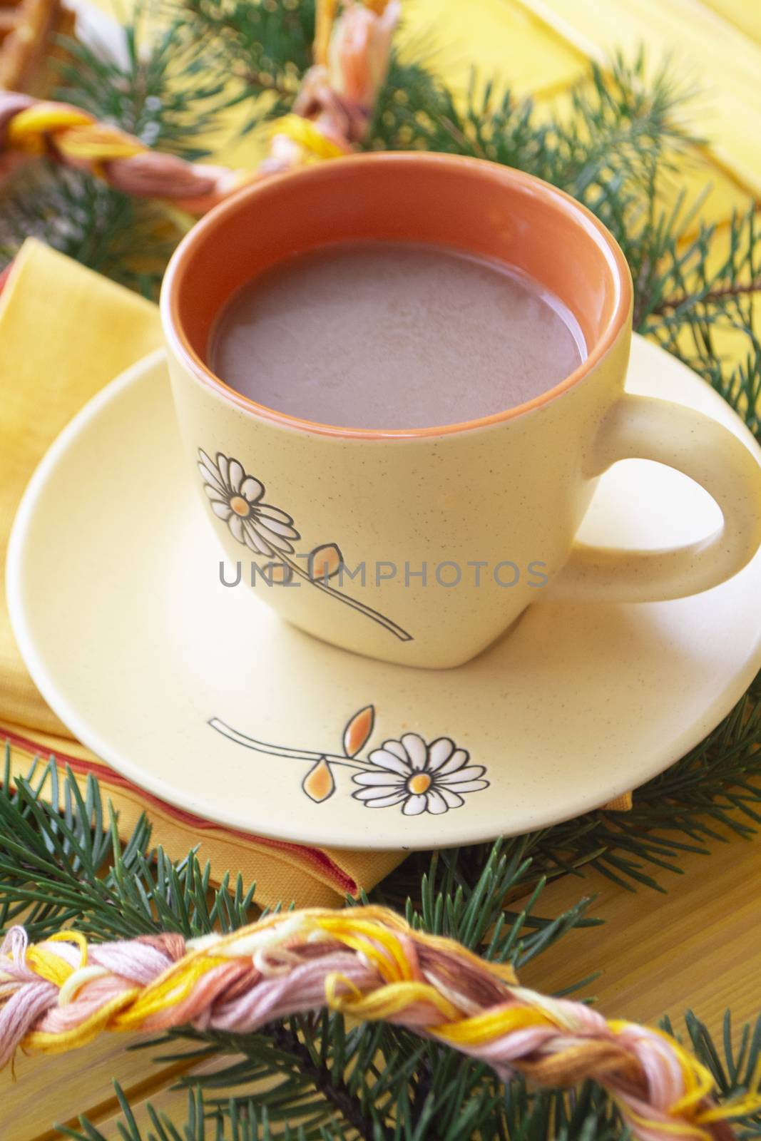 Christmas hot chocolate in a orange cup on orange wooden board. Vertical image