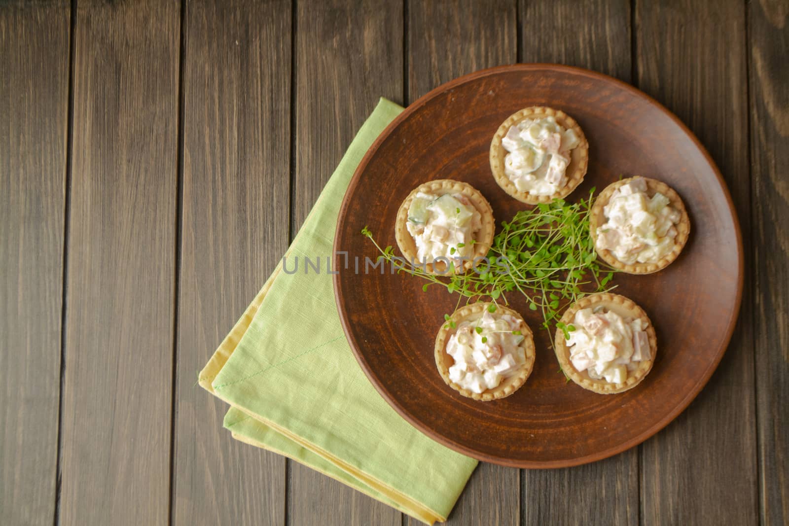 Traditional russian salad olivier in tartlets, top view