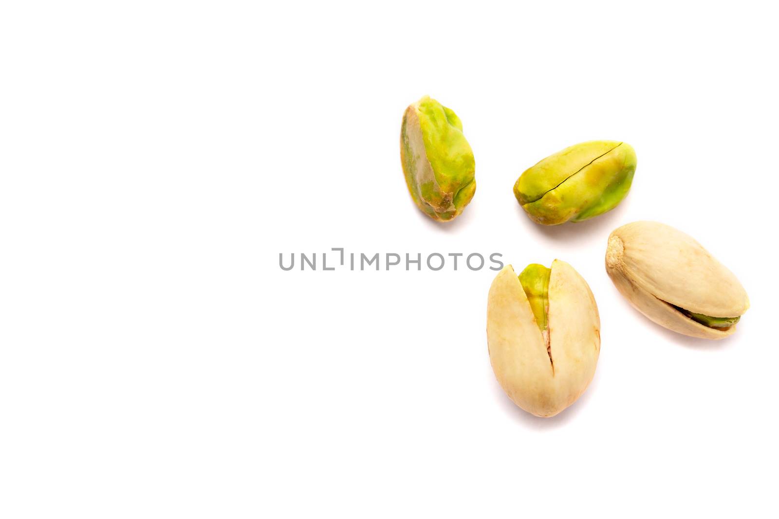 Some Pistachio nuts on a white background