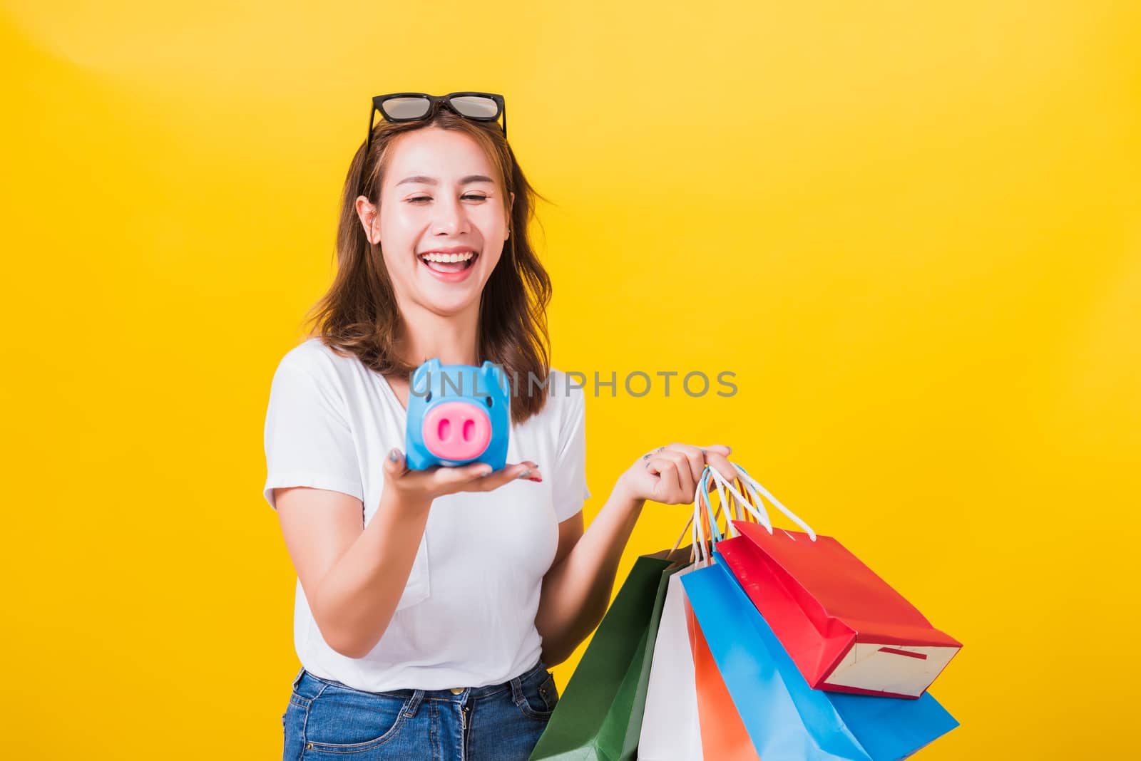woman happy hold colorful shopping bags and Piggybank Saving mon by Sorapop