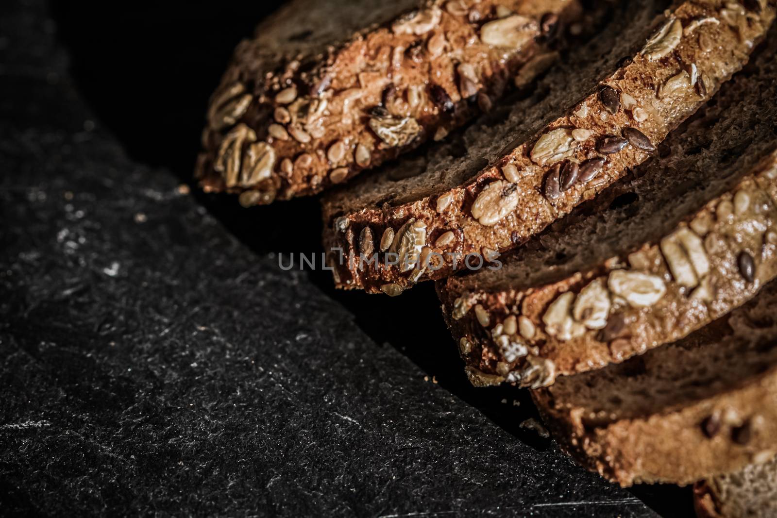 Fresh whole grain seeded bread, organic wheat flour, closeup sli by Anneleven