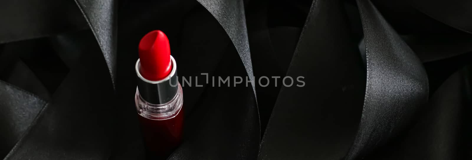 Red lipstick on black silk background, luxury make-up and beauty cosmetics