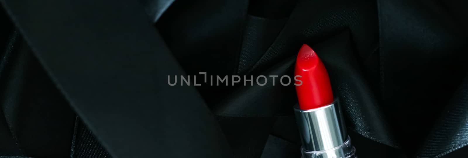 Red lipstick on black silk background, luxury make-up and beauty by Anneleven