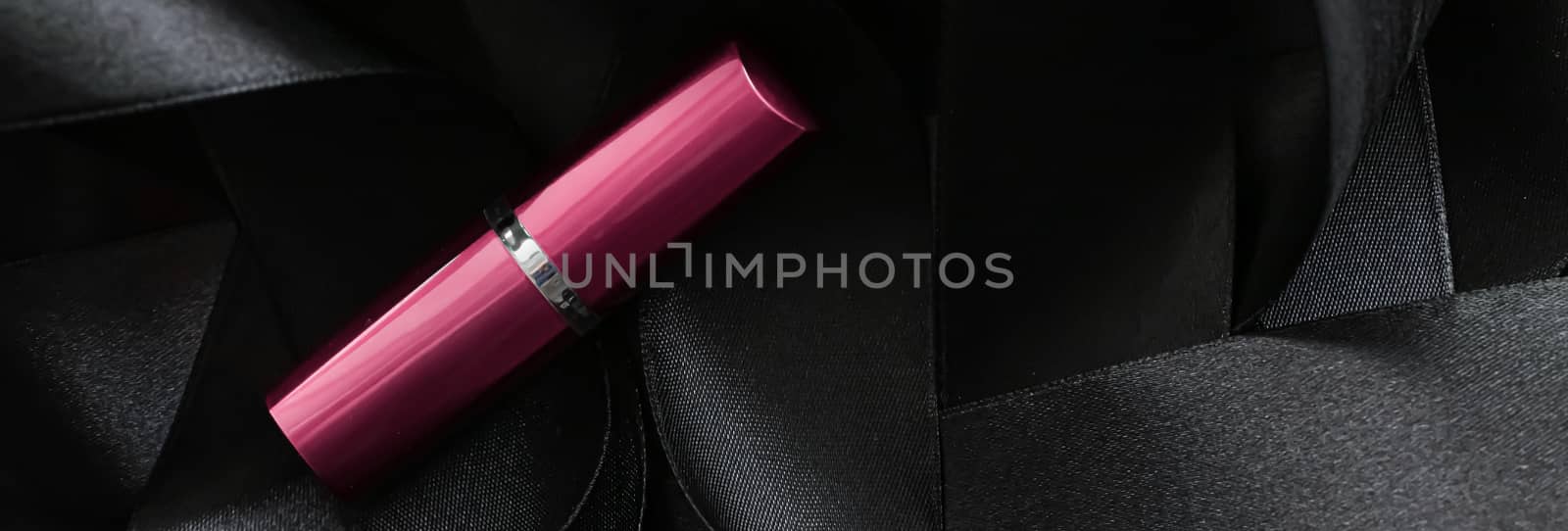 Pink lipstick on black silk background, luxury make-up and beauty cosmetics