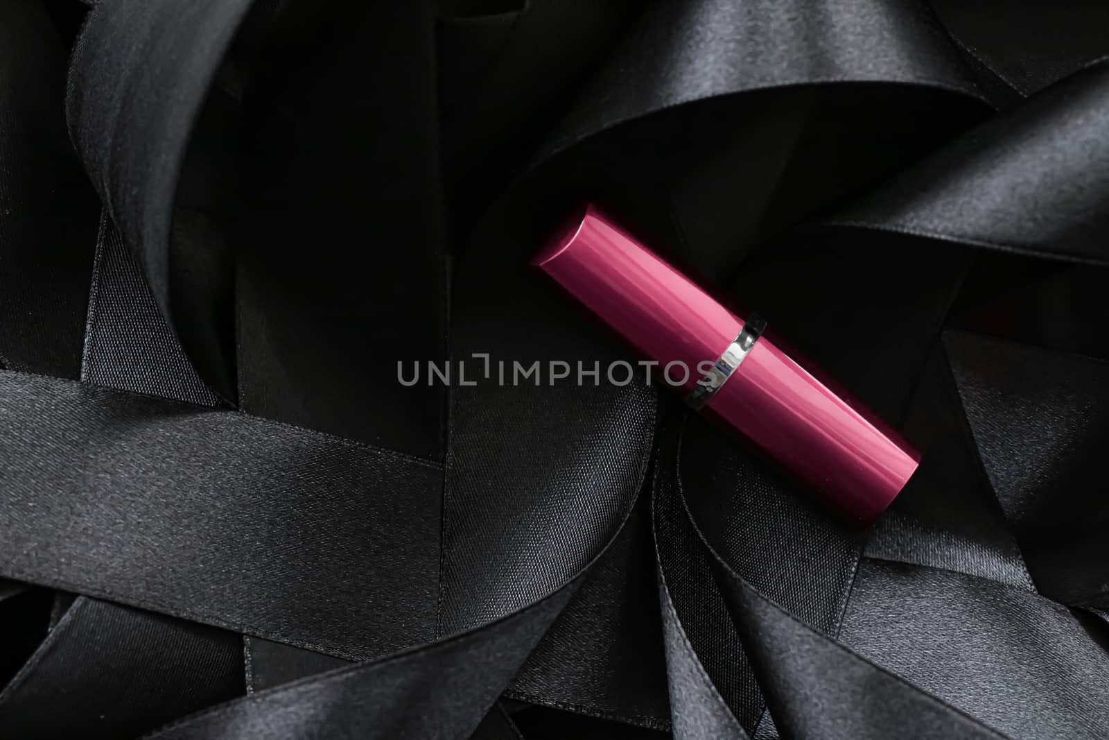 Pink lipstick on black silk background, luxury make-up and beauty cosmetics